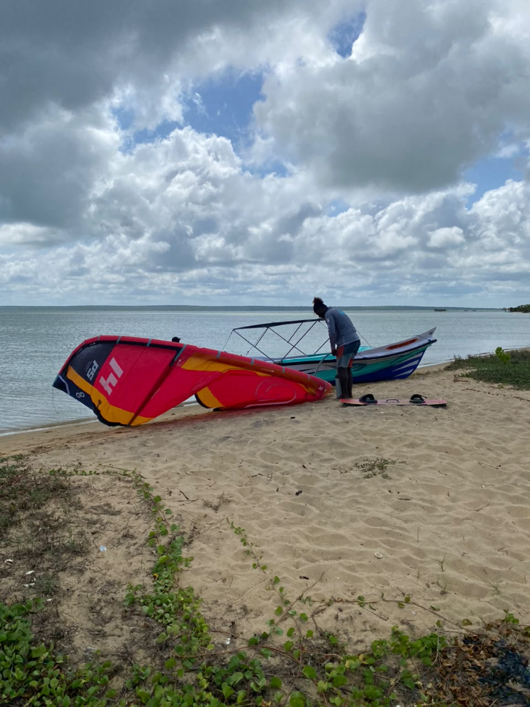Kitesurfing gear and a boat on the shore of Puttalam Lagoon
